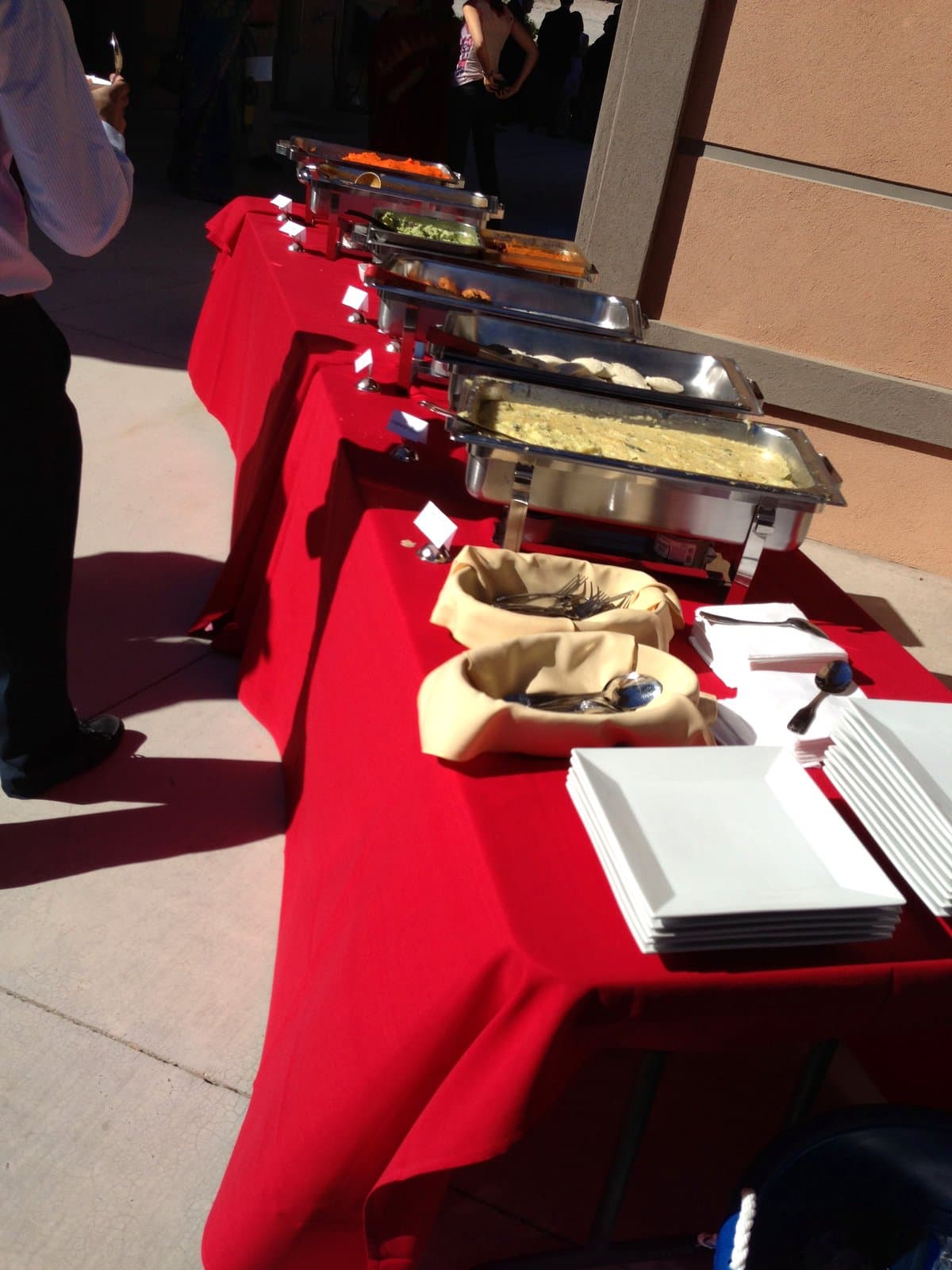 Outdoor Indian buffet line with chafing dishes at a Mint catering event